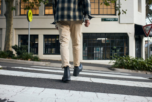 A person walking across a crosswalk.