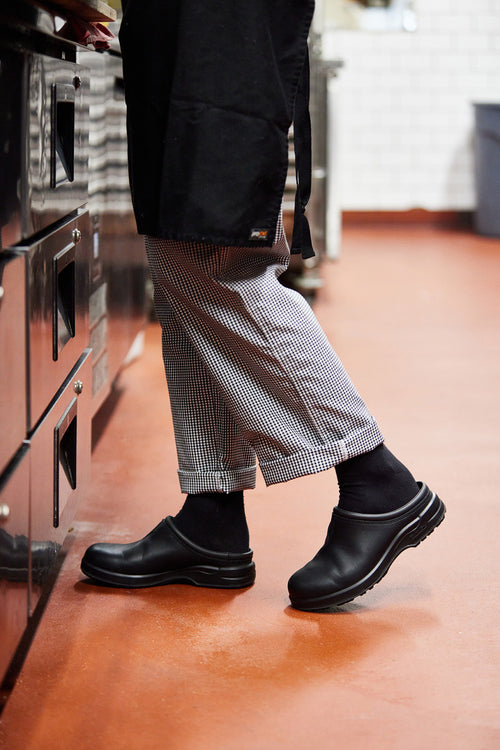 A person wearing black shoes.