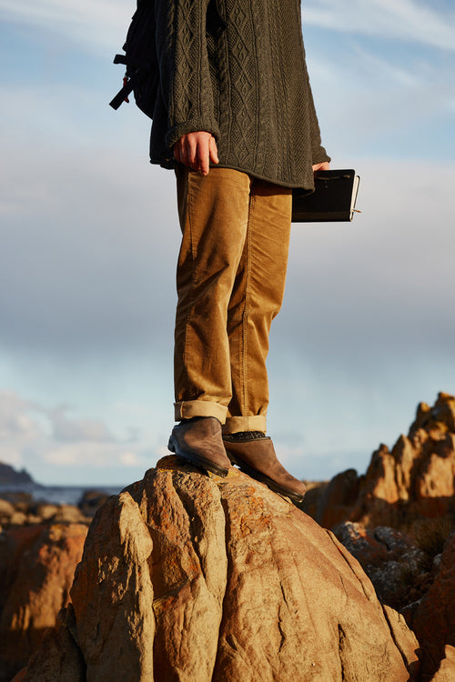 A person standing on a rock.
