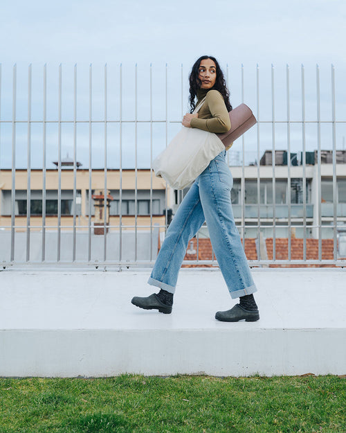 A woman walking on a step.